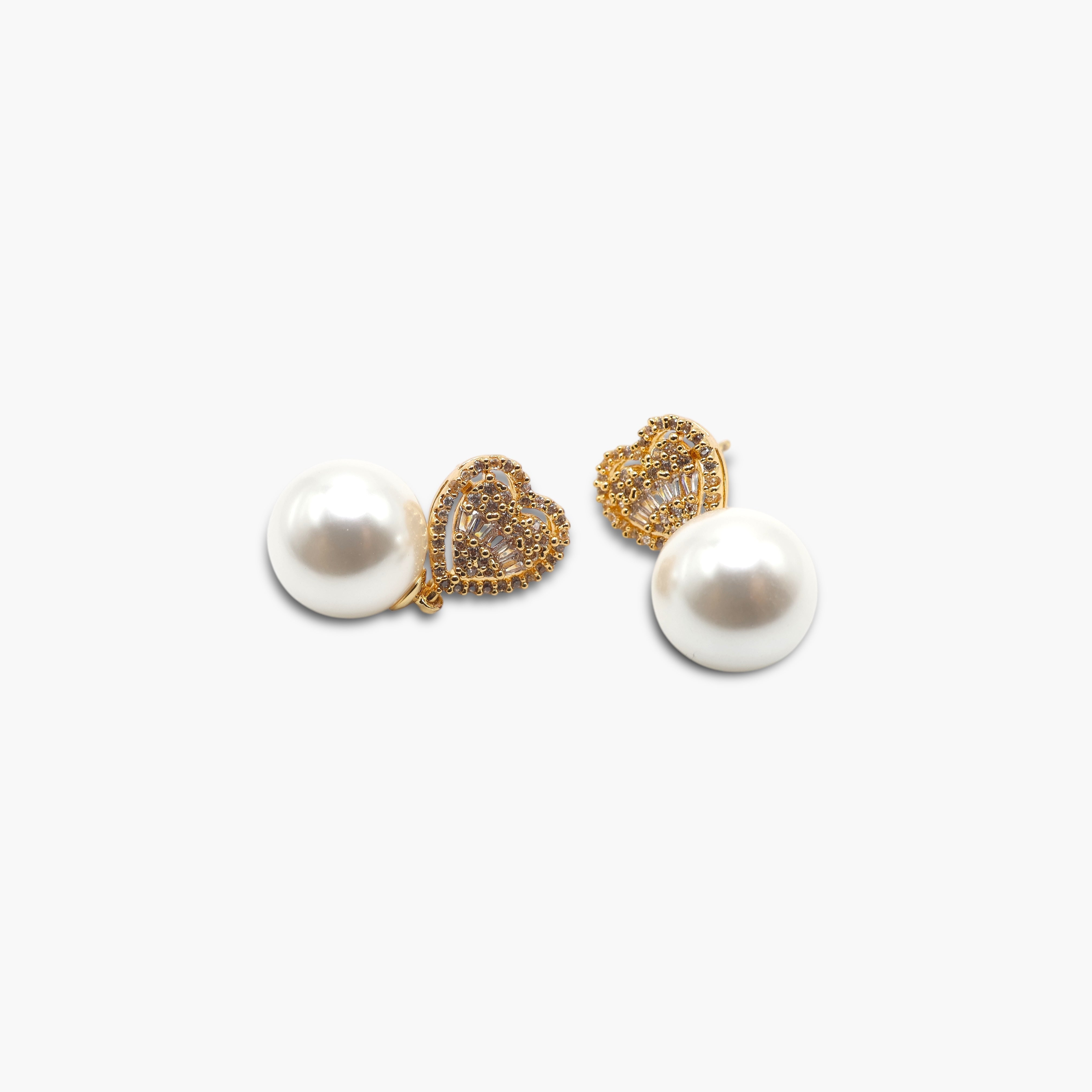 A pair of baguette cut pearl earrings with a heart-shaped pearl in the center, attached to small round pearls, with a gold-tone post and clasp.