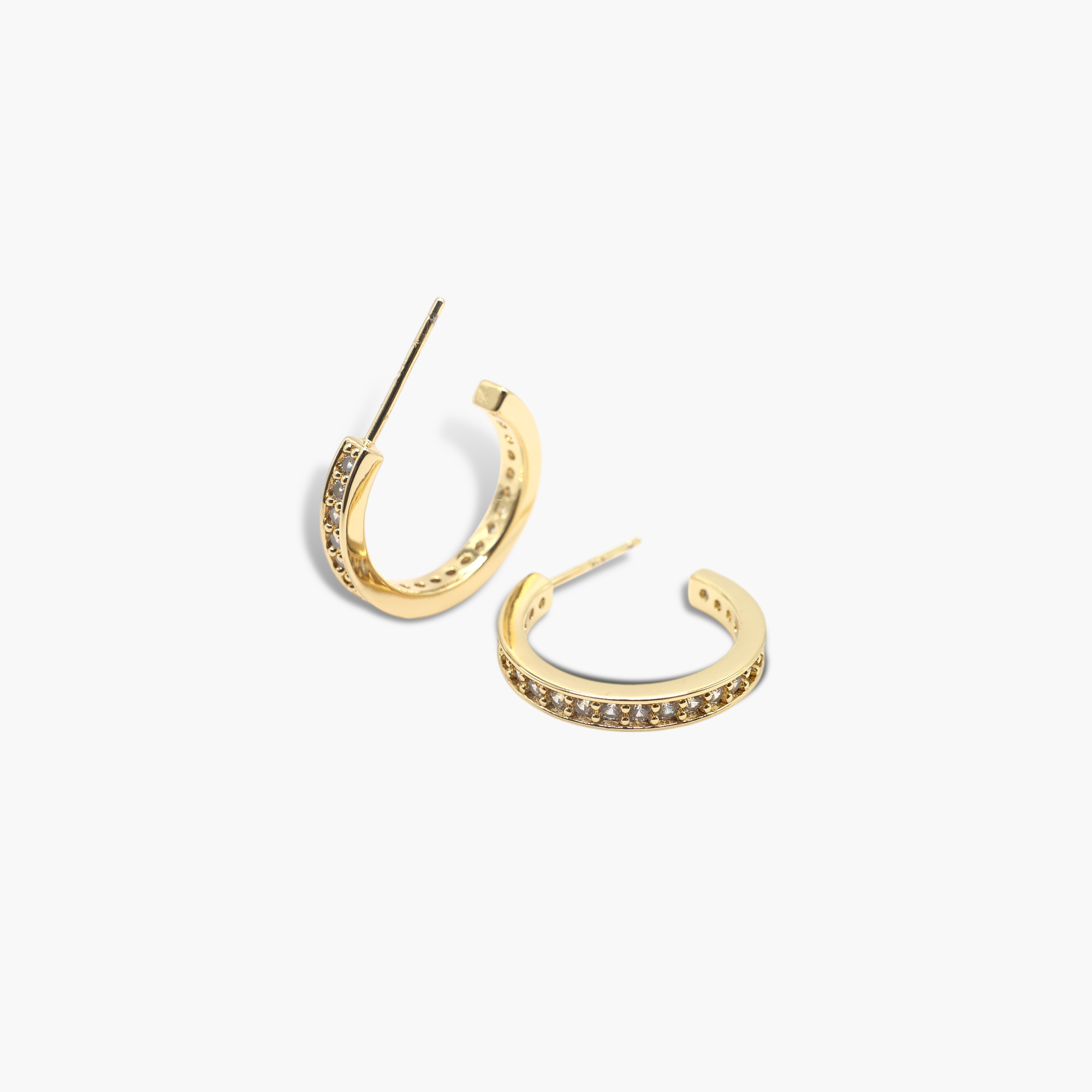 A pair of gold-colored hoop earrings with a small open hoop design and adorned with pave stones.