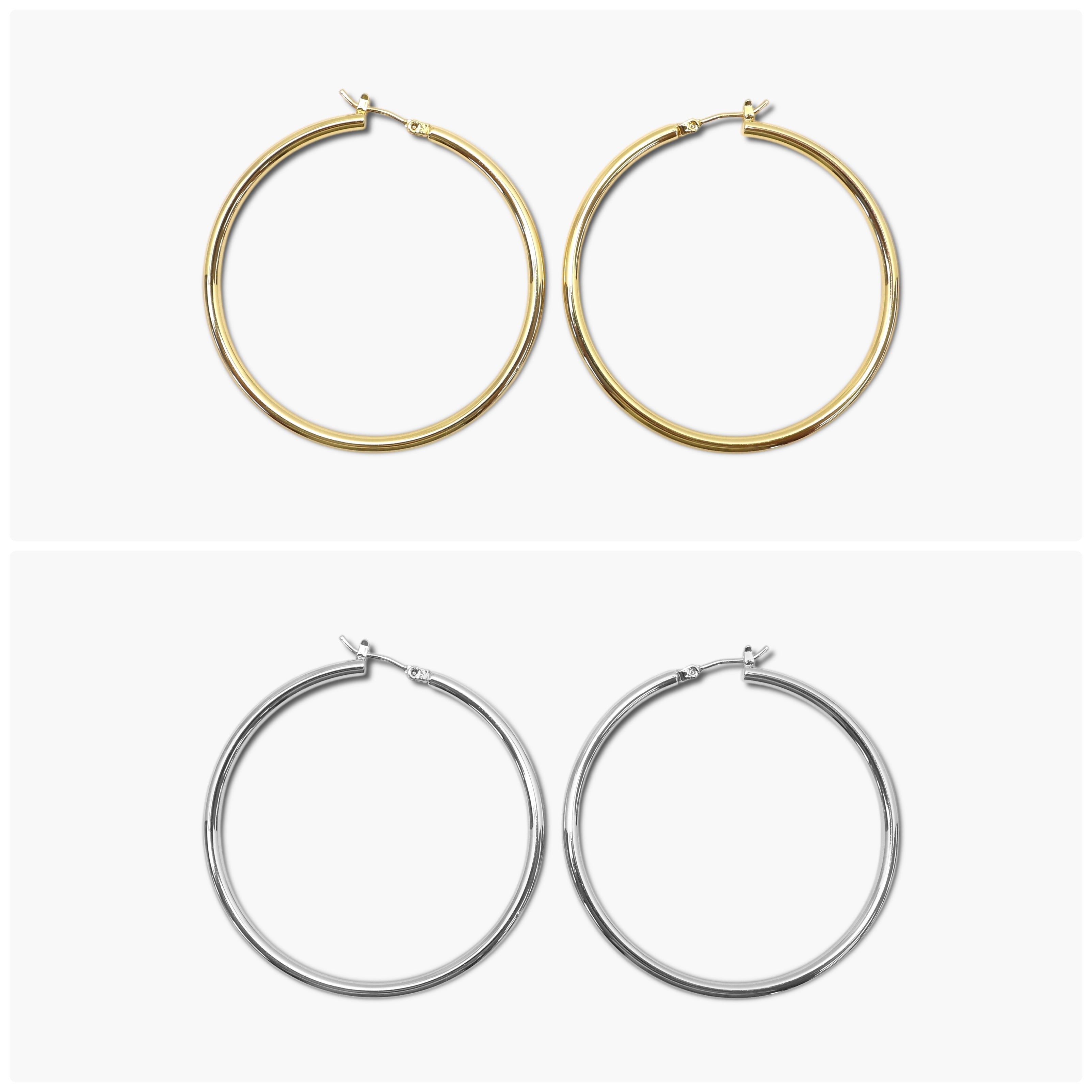A pair of gold-colored hoop earrings with a textured surface, displayed against a white background. The earrings have a shiny finish and are shown in two different orientations.