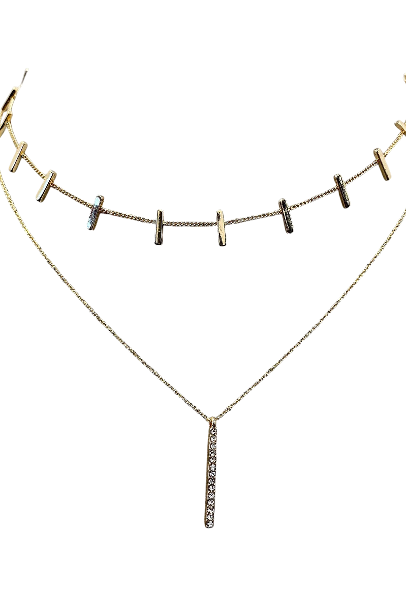 Gold necklace with small pendant on a white background