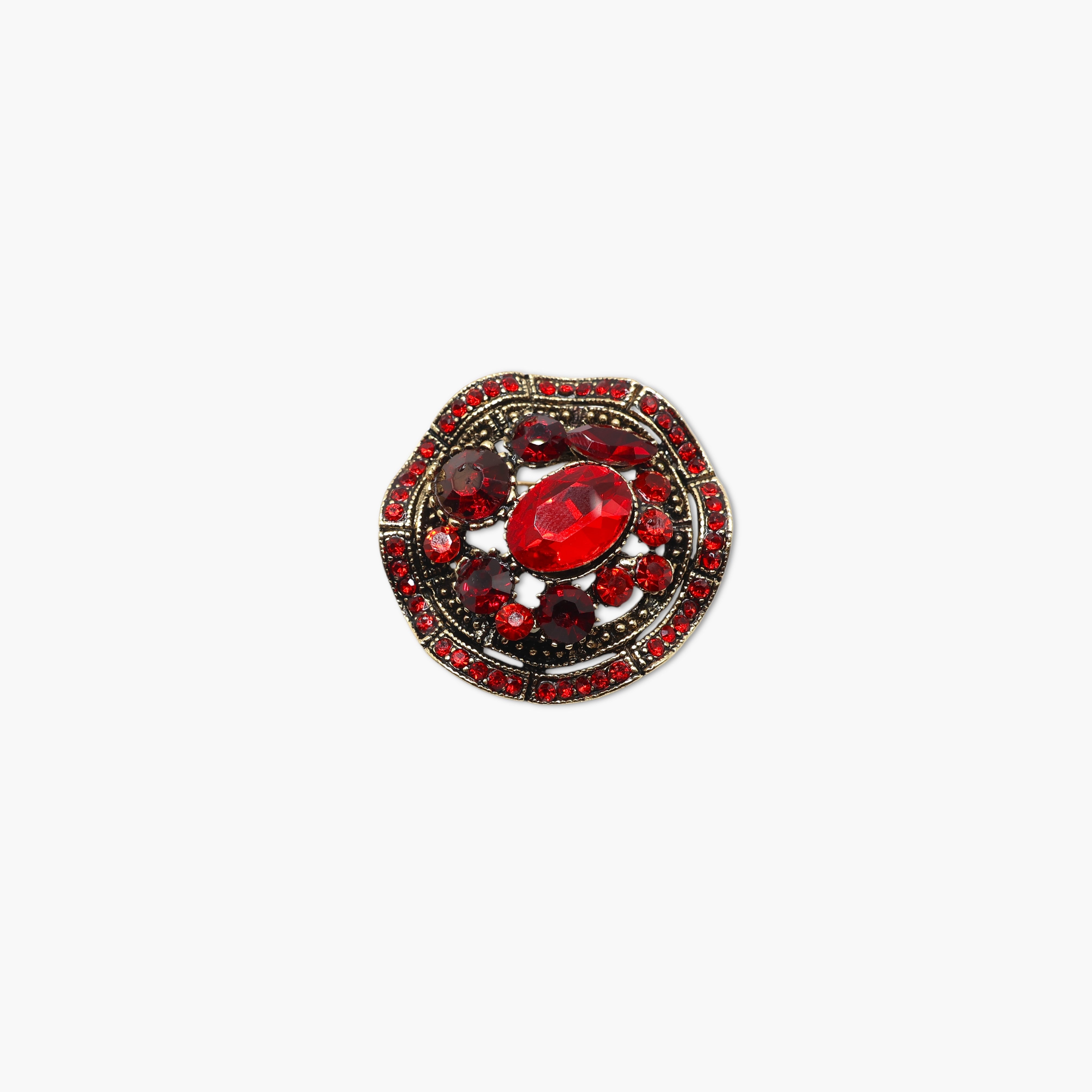 Decorative brooch with red gemstone on a white background