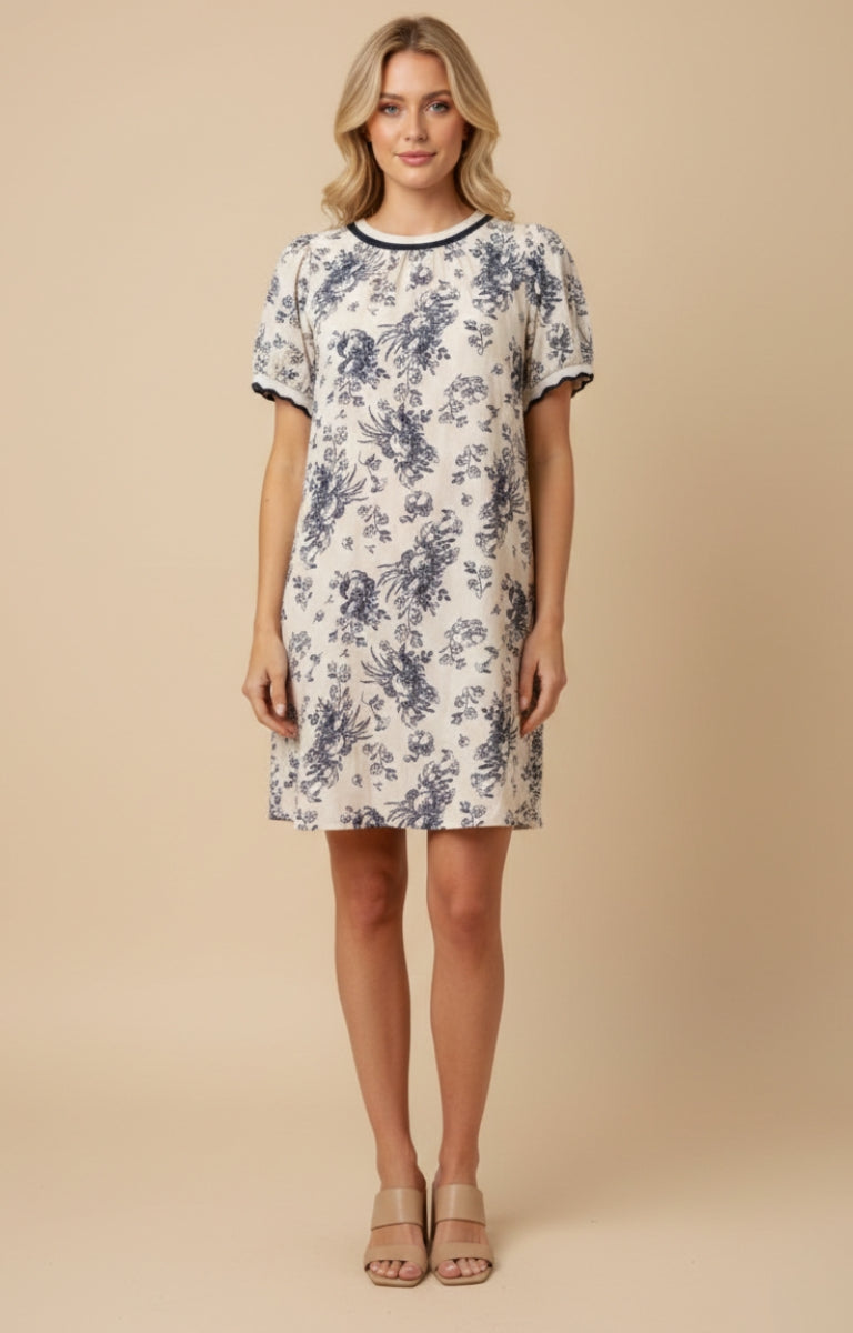 Woman wearing a floral dress against a beige background
