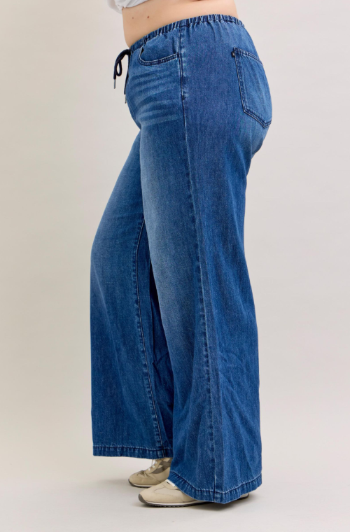 Blue wide-leg jeans on a plain background