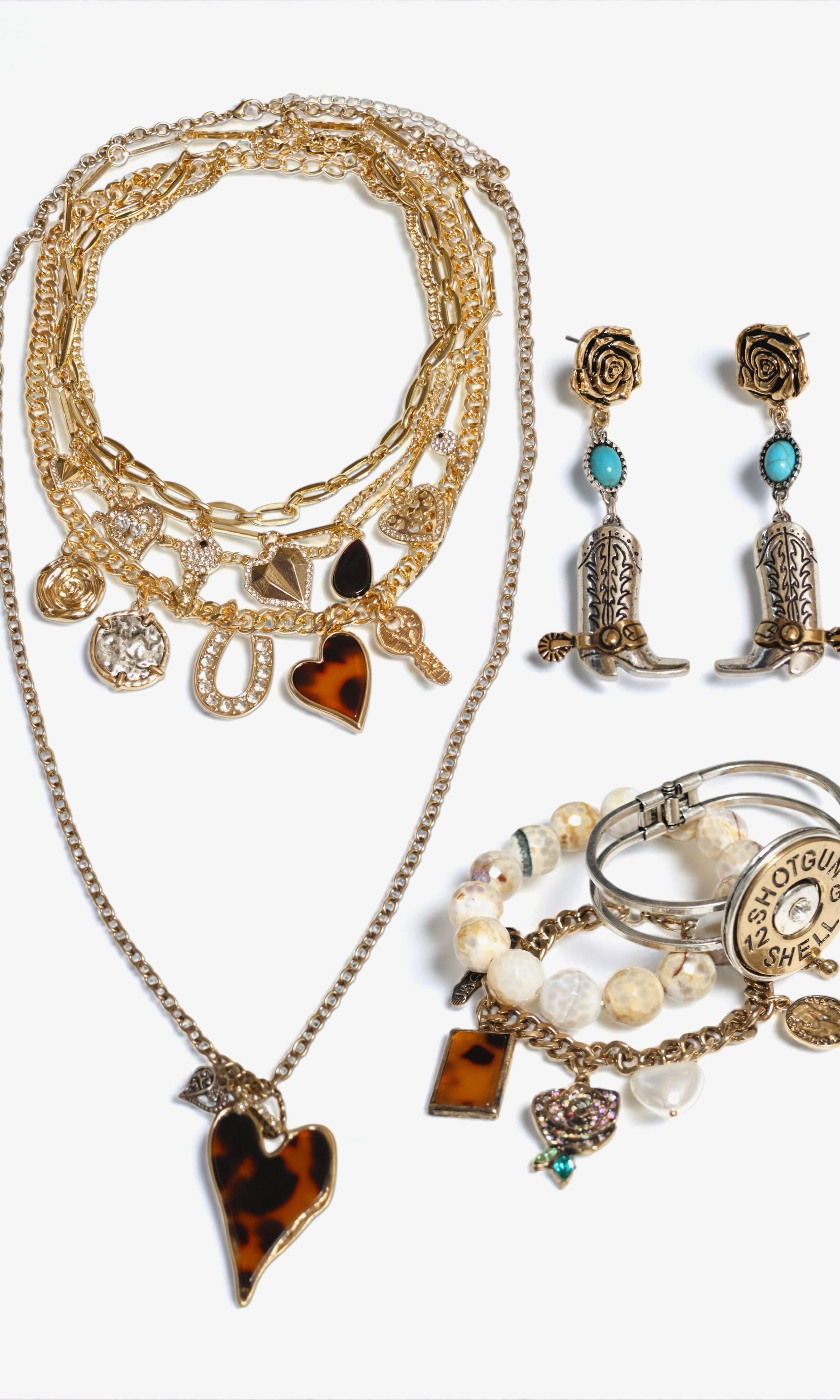 Jewelry set with necklace, earrings, and rings on a white background