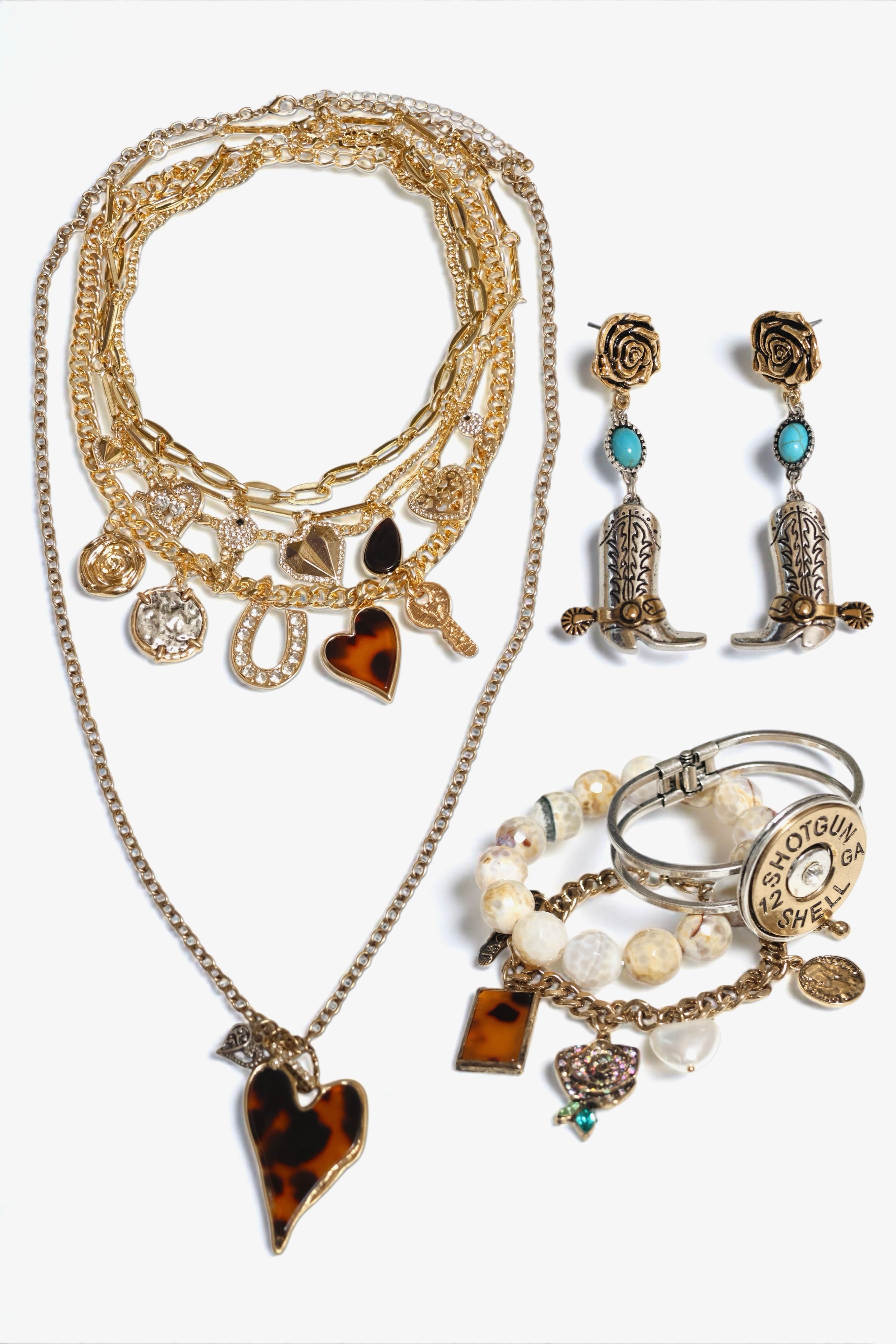 Jewelry set with necklace, earrings, and rings on a white background