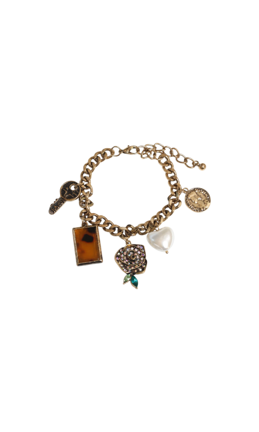 Gold charm bracelet with various charms on a white background