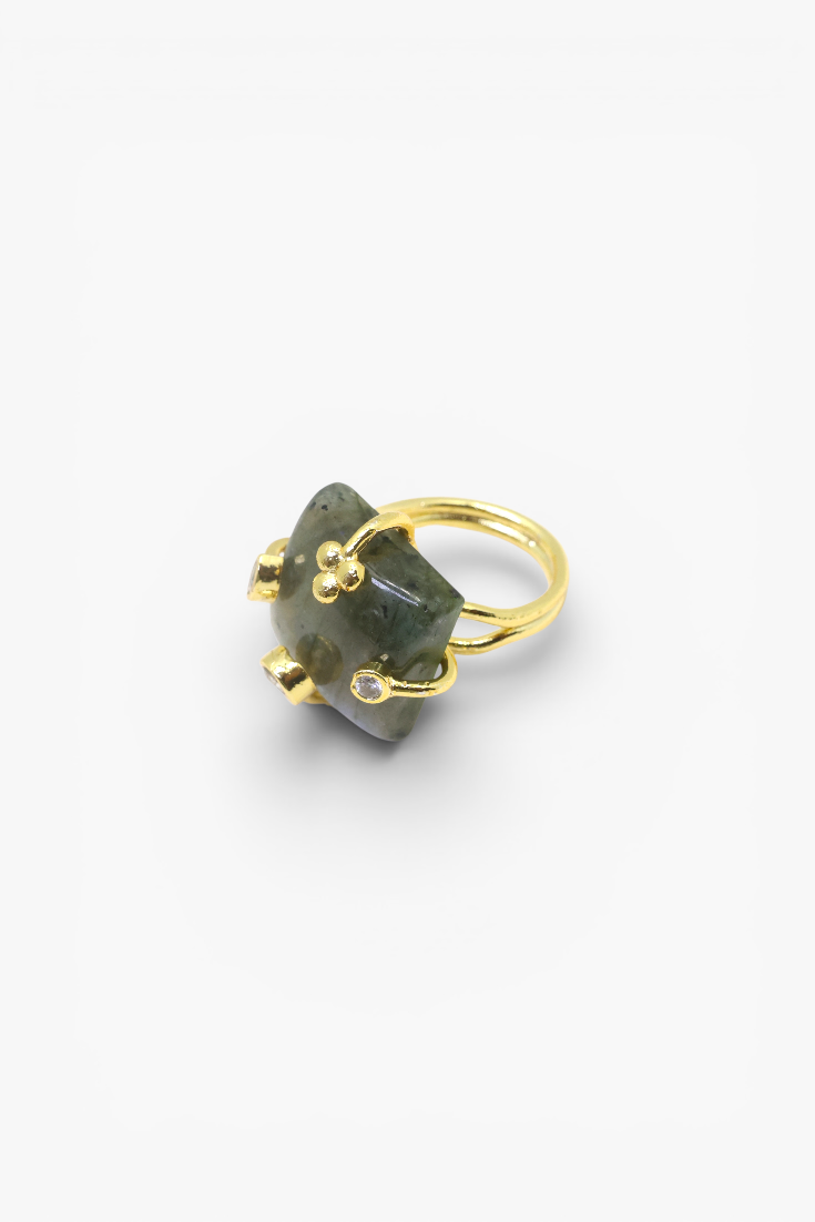 Natural stone statement ring with crystal accents in a gold-tone setting featuring an organic gemstone design.
