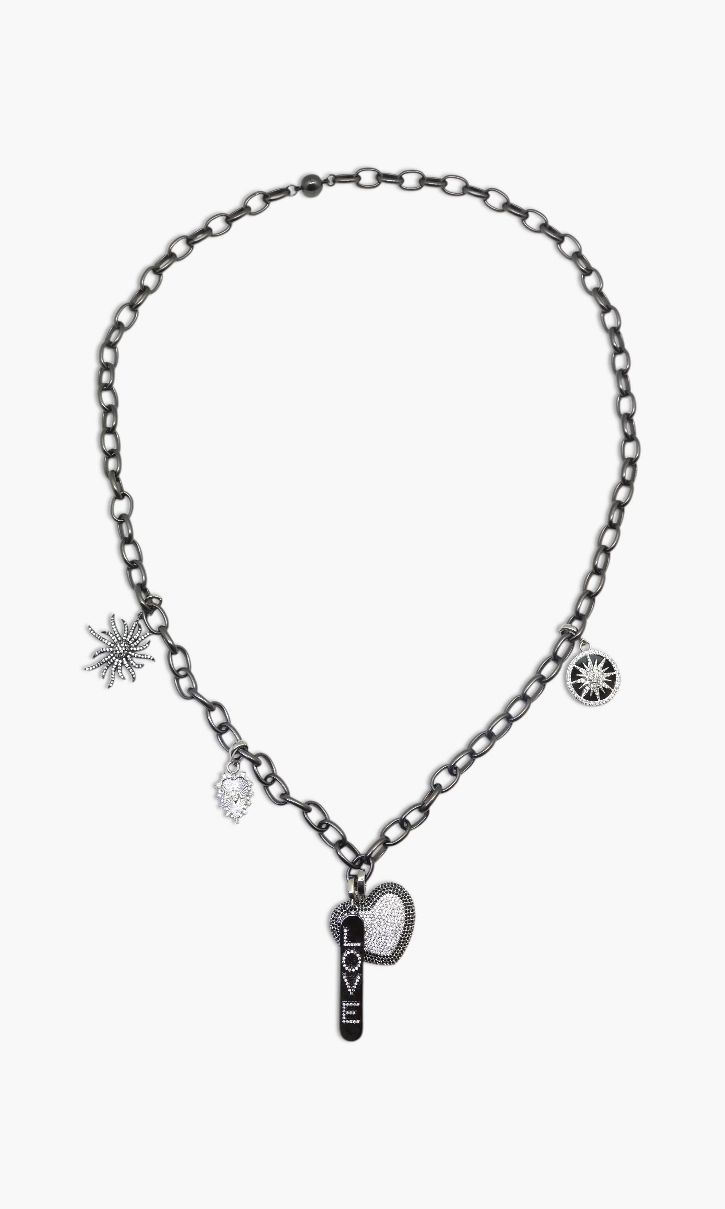 A person wearing multiple necklaces with onyx and gun metal colors.