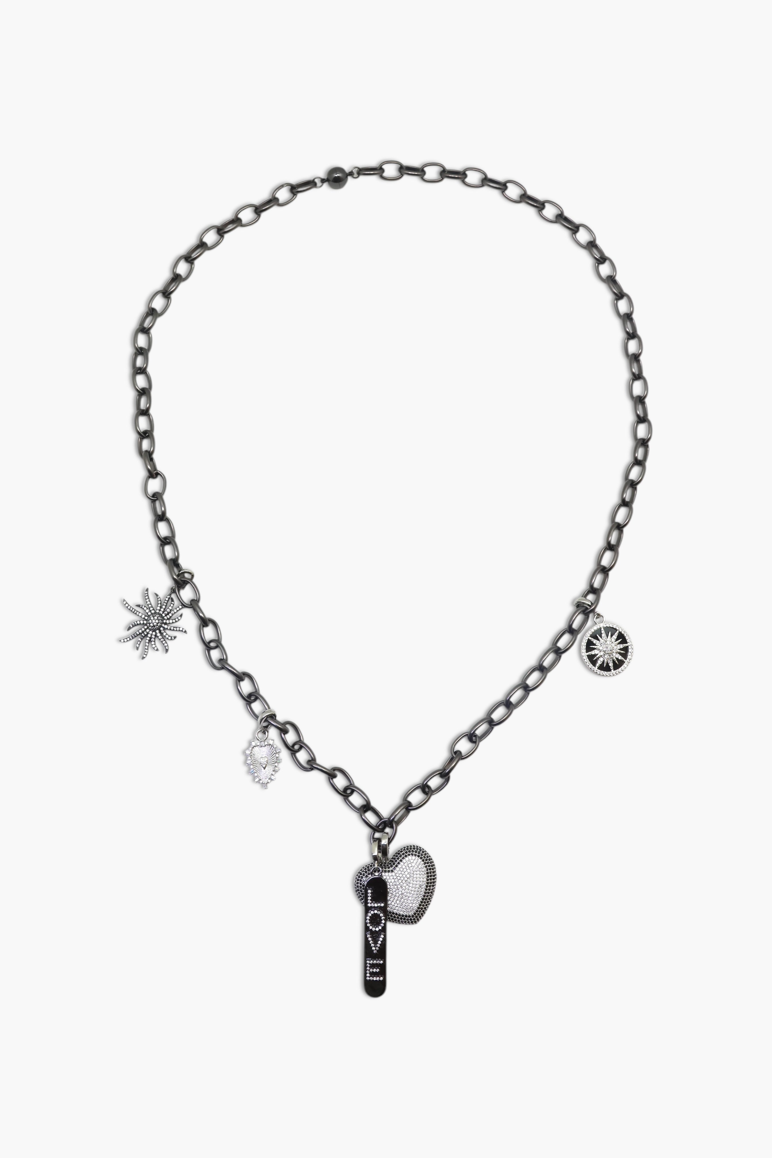 A person wearing multiple necklaces with onyx and gun metal colors.