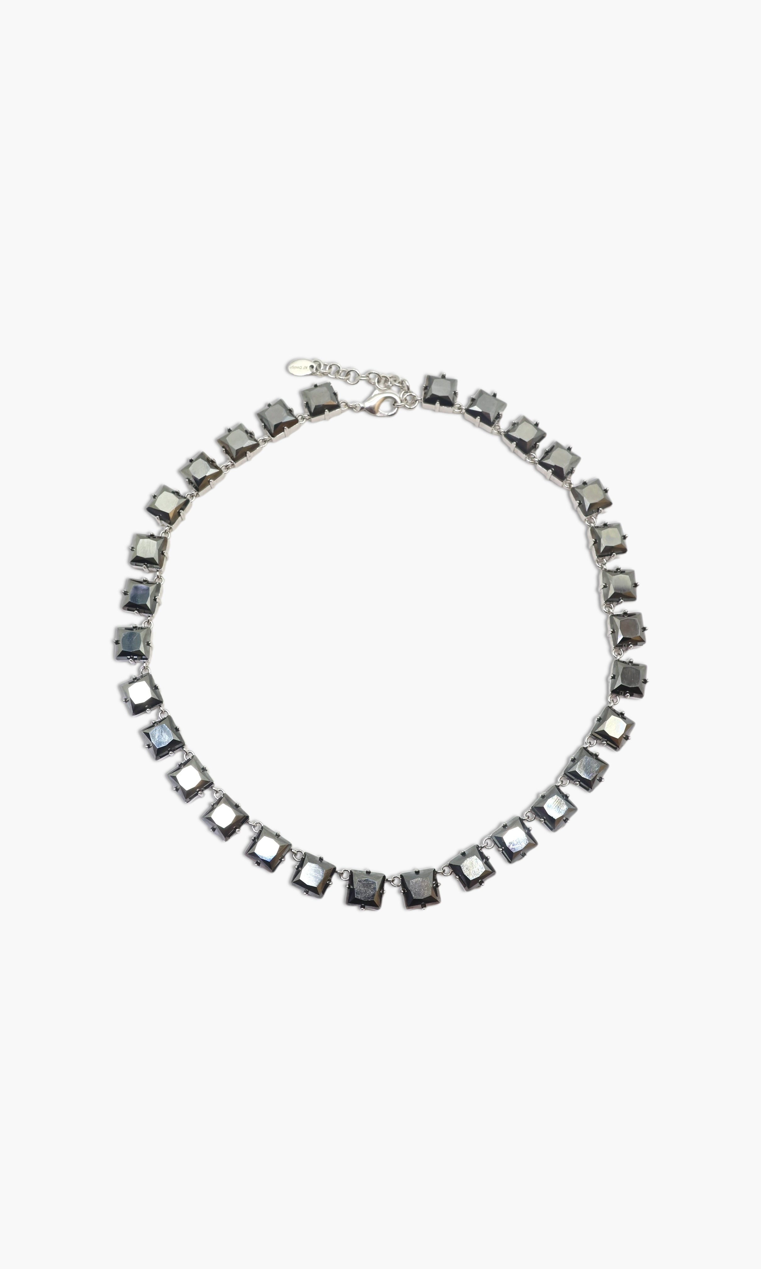 A person wearing multiple necklaces with onyx and gun metal colors.