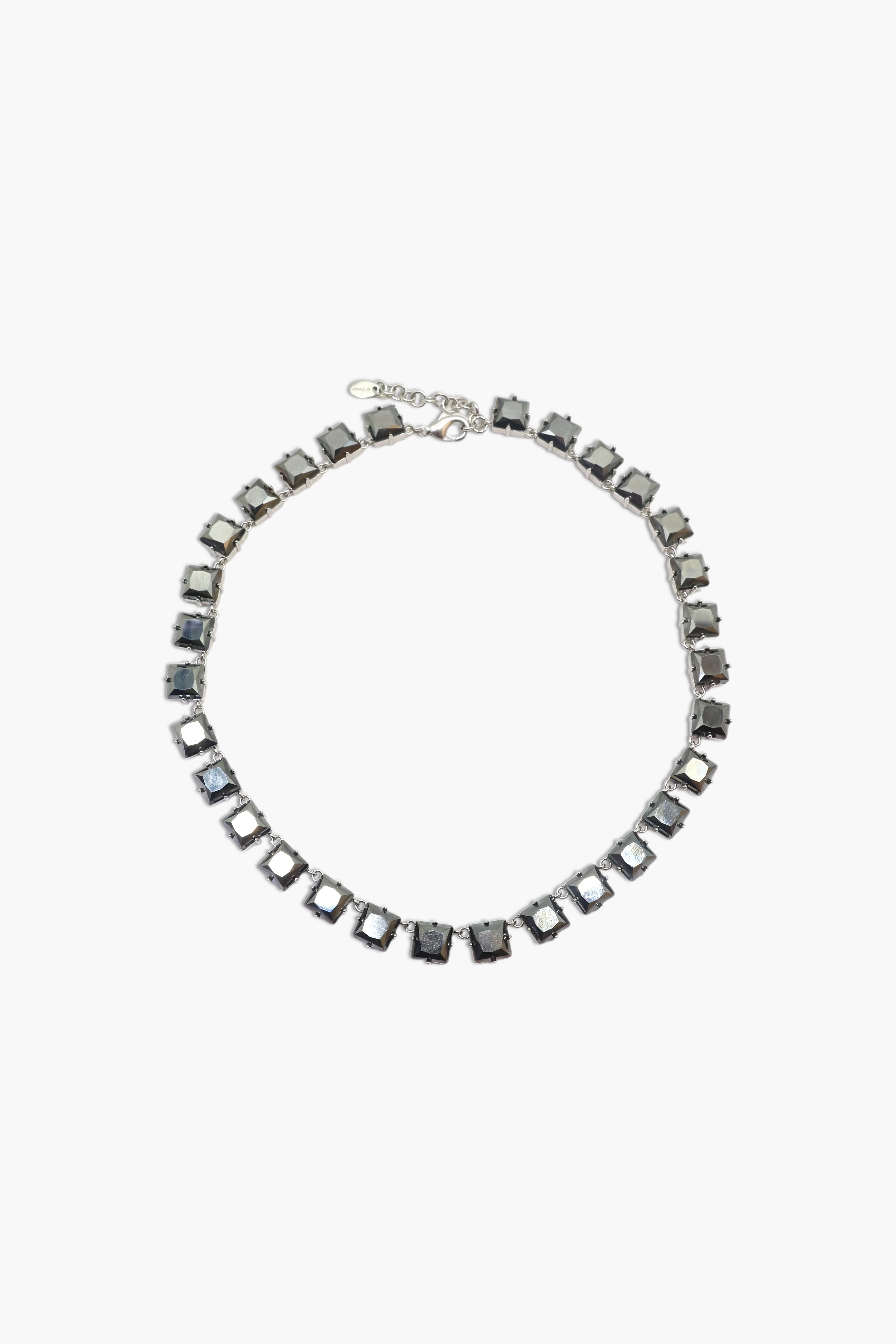 A person wearing multiple necklaces with onyx and gun metal colors.