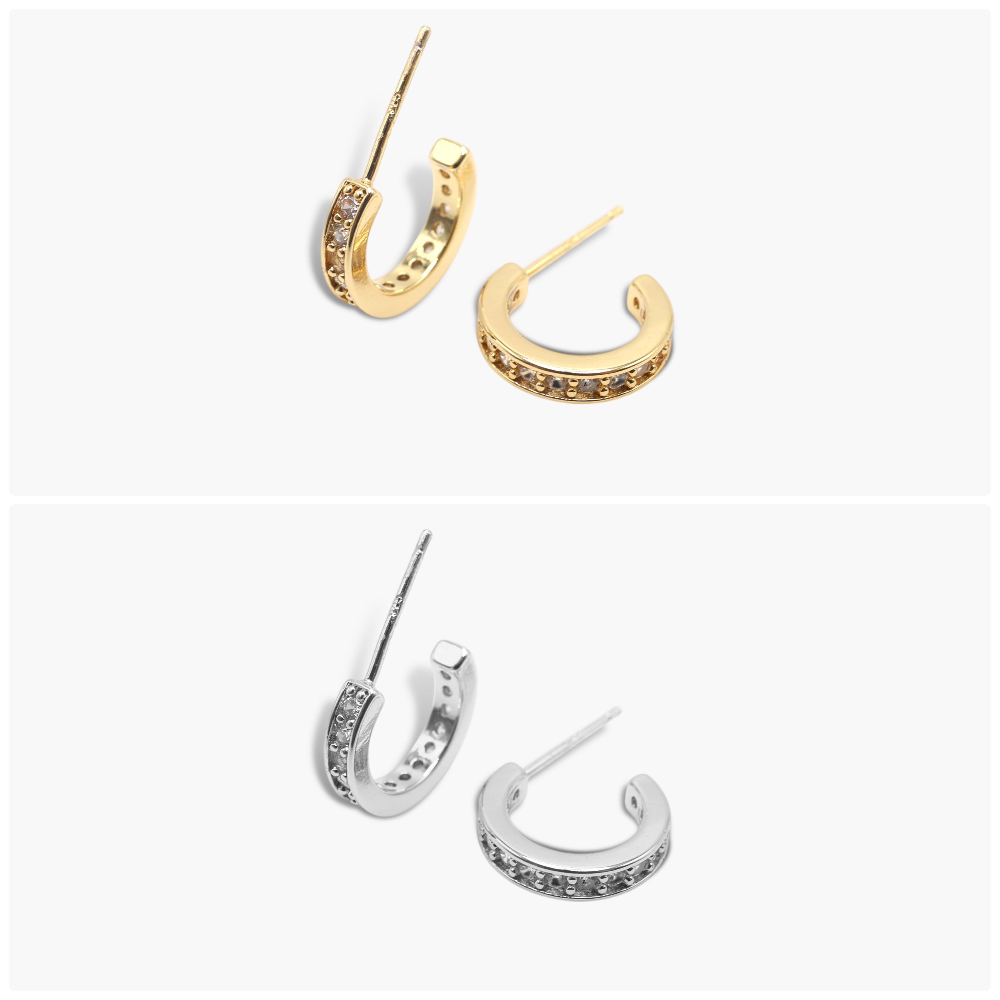 A pair of gold-colored hoop earrings with open hoops and small dangling embellishments, displayed against a white background.