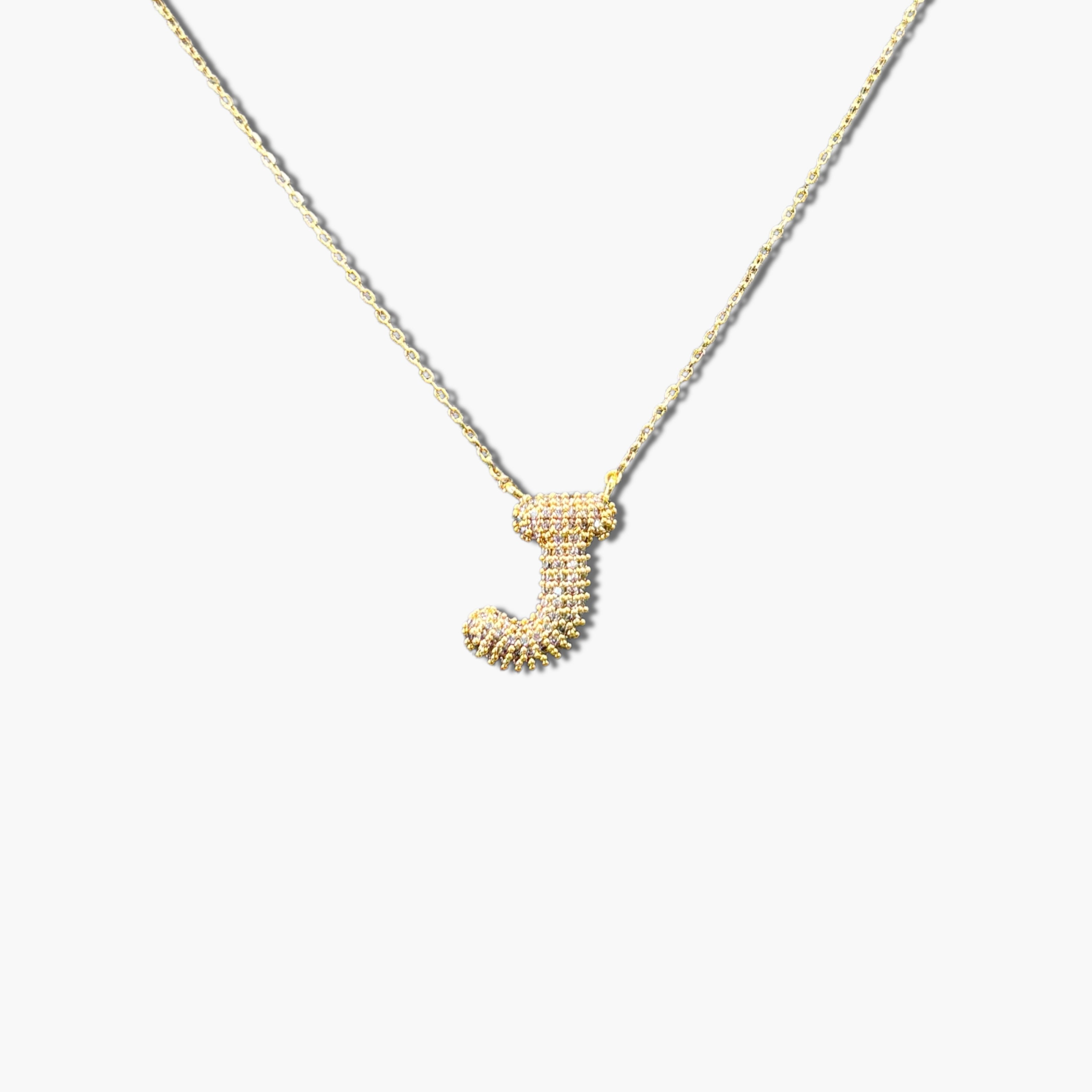 A gold-plated letter necklace with a pleated design on the pendant.