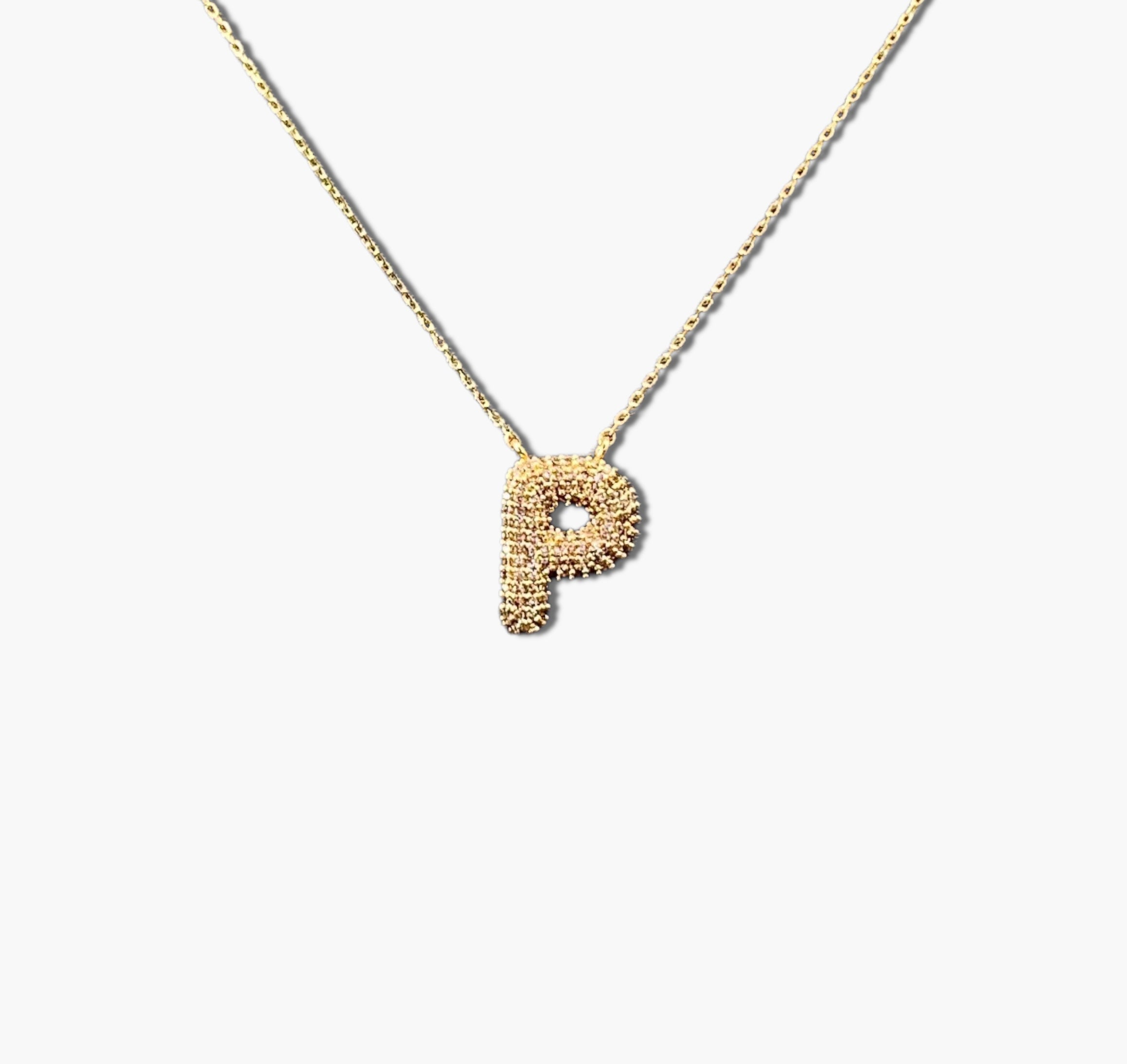 A gold-plated letter necklace with a pleated design on the pendant.
