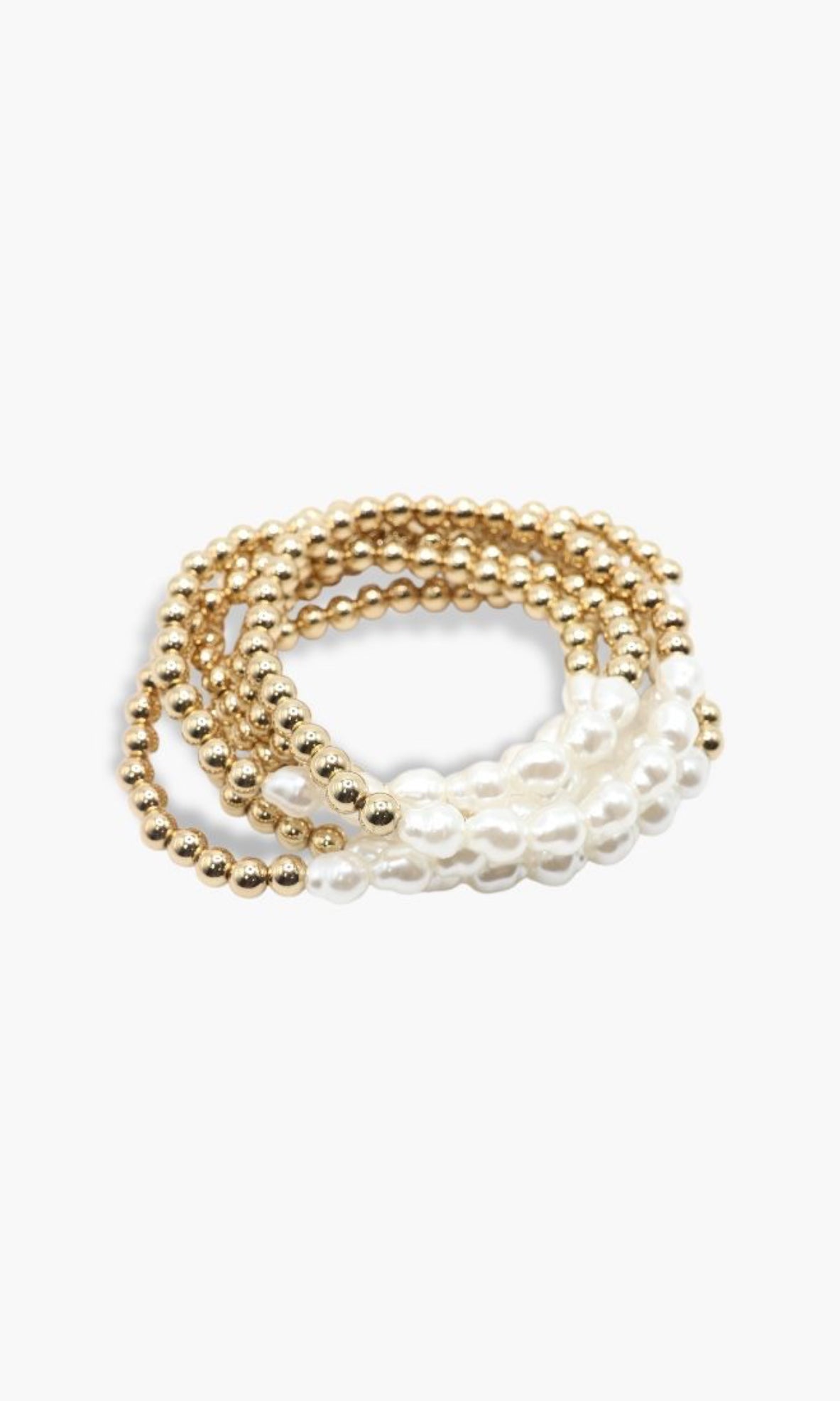 Set of gold and pearl bracelets on a white background