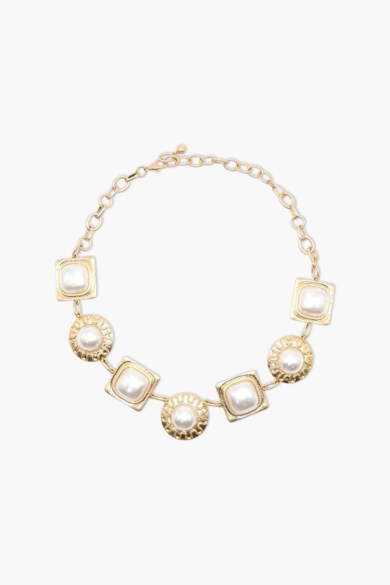 Gold necklace with square and round pendants on a white background