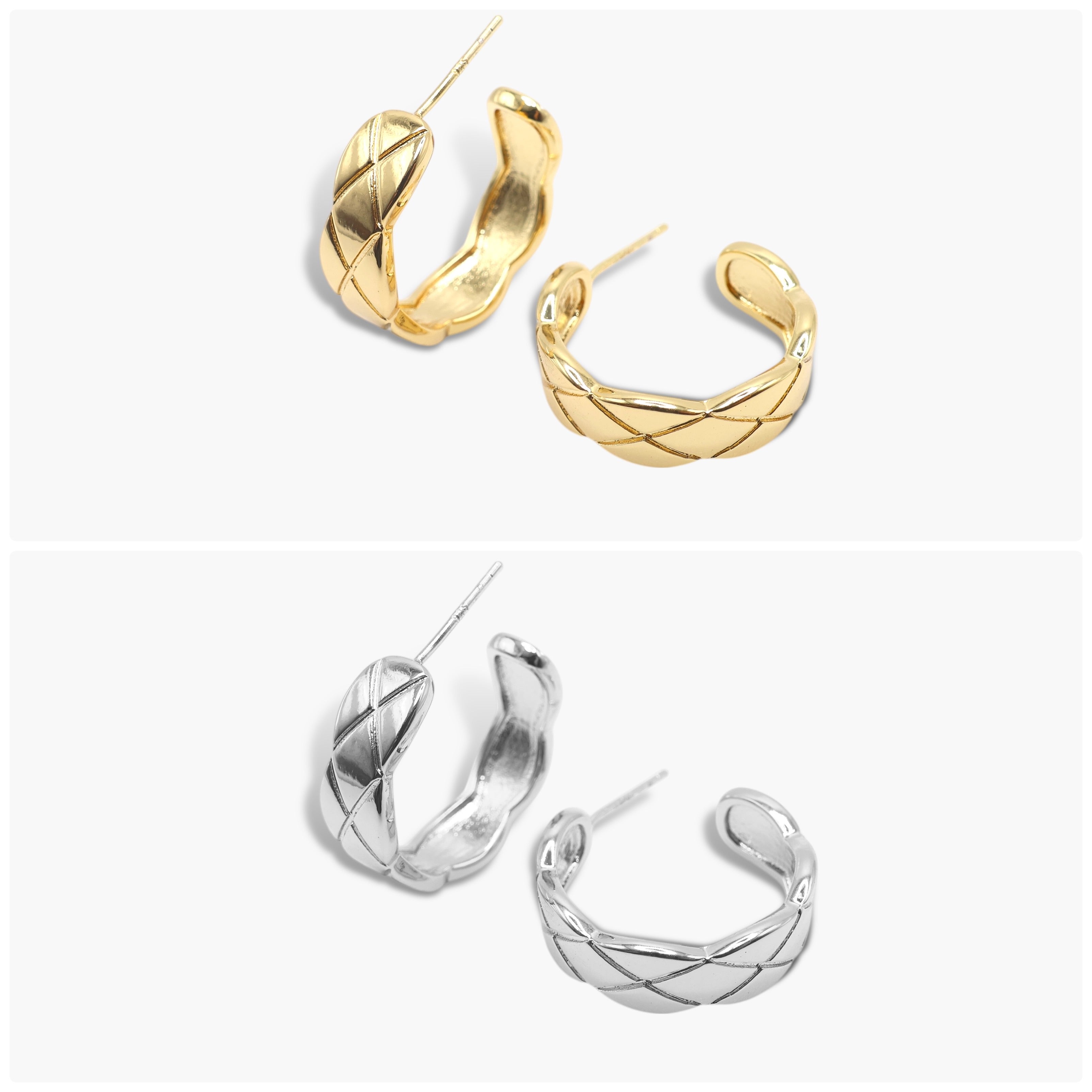 A pair of gold-colored hoop earrings with a textured surface, displayed against a white background. The earrings have a bohemian style with an open hoop design.