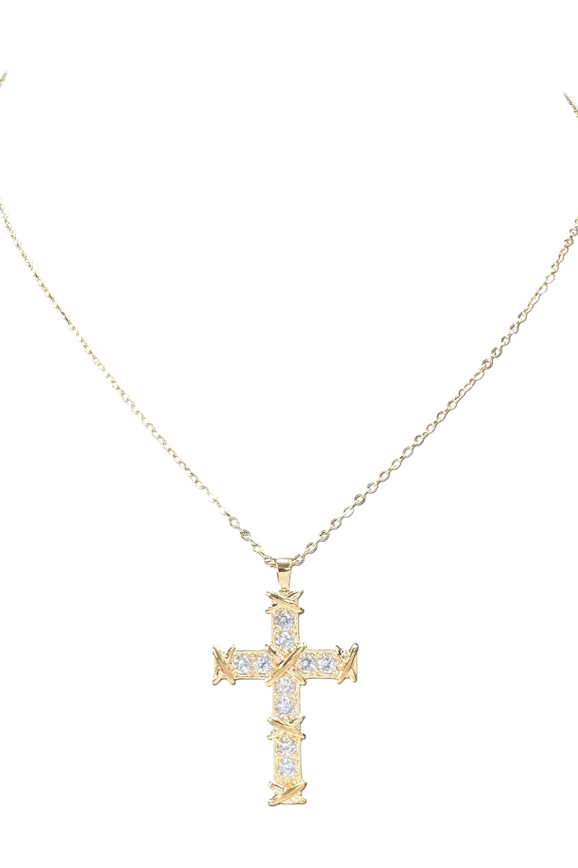 Gold cross necklace with diamonds on a white background