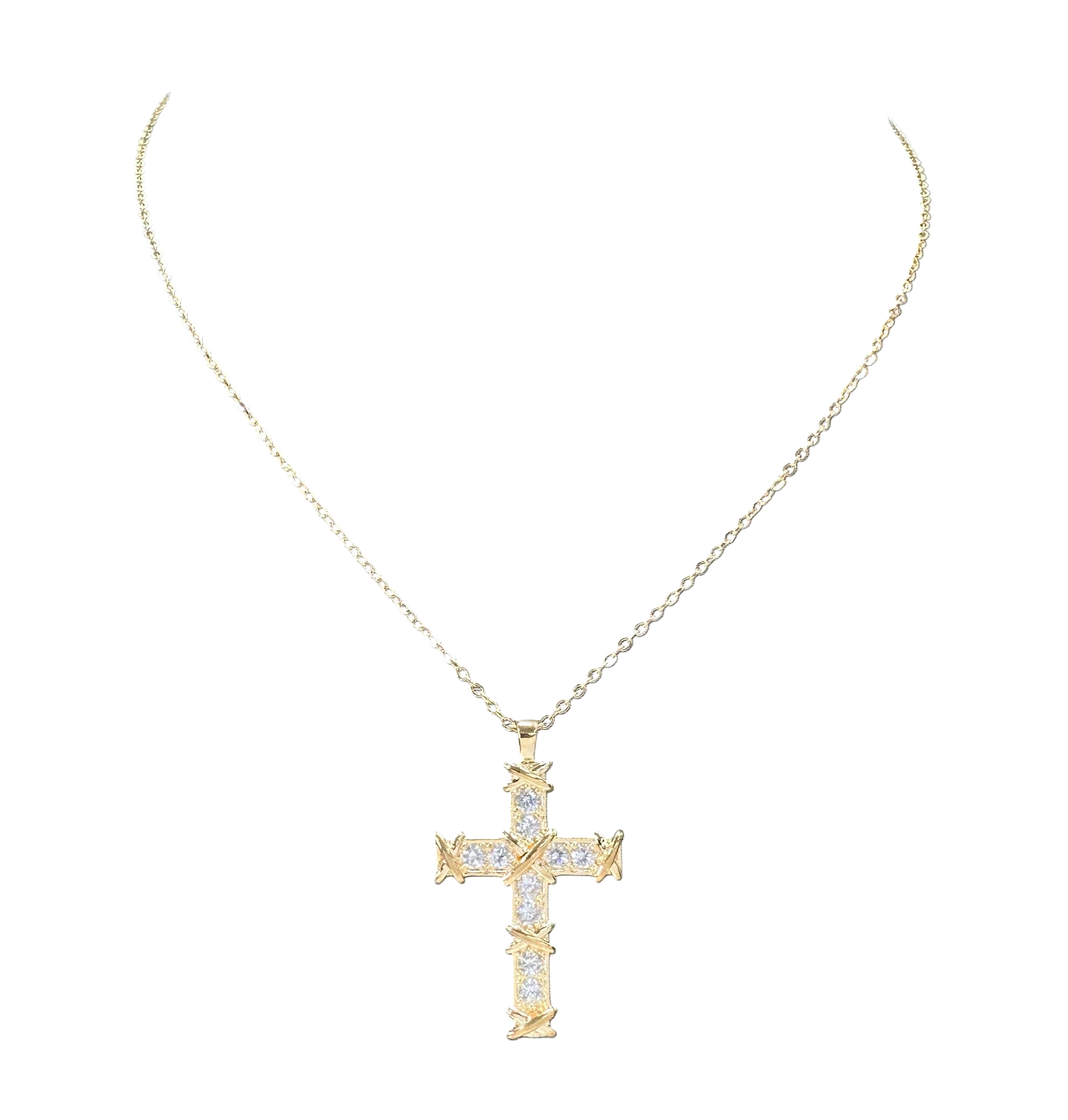 Gold cross necklace with diamonds on a white background
