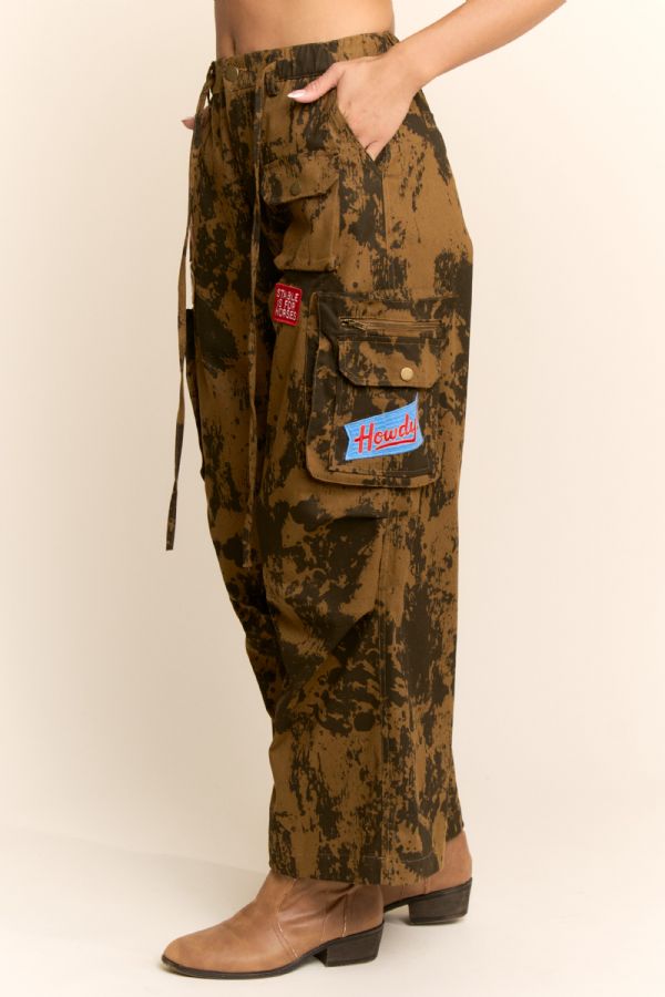 Camouflage pants with patches on a beige background