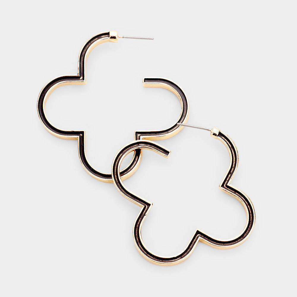 A pair of gold-colored clover-shaped post back earrings on a white background.