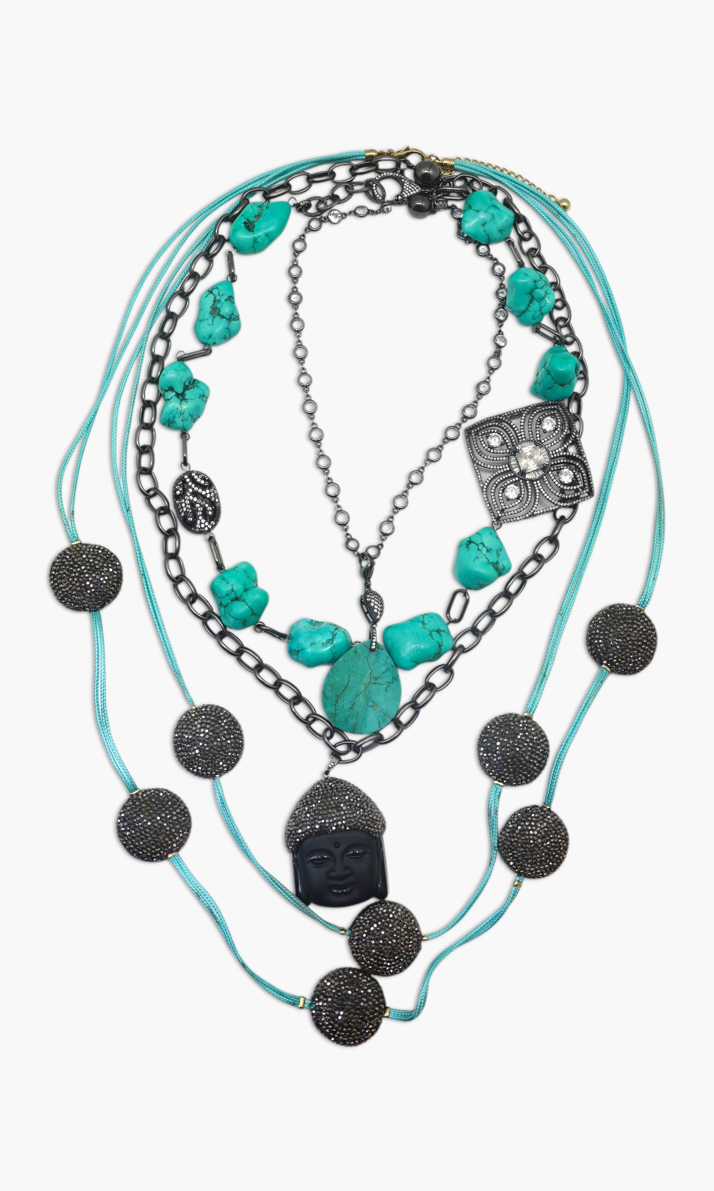 A piece of jewelry with multiple strands, featuring black coins, turquoise stones, and a watch-like component