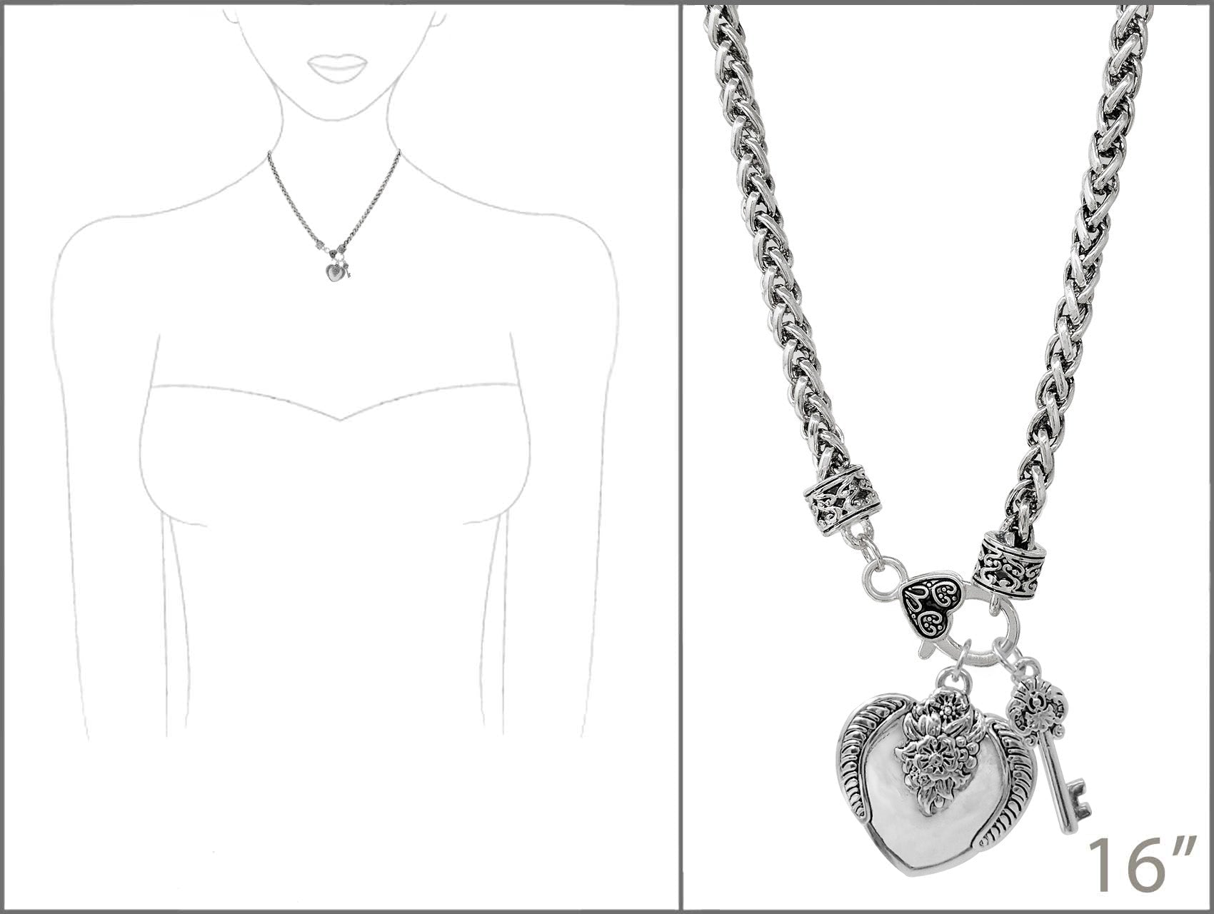 Silver necklace with heart and key pendant on a white background