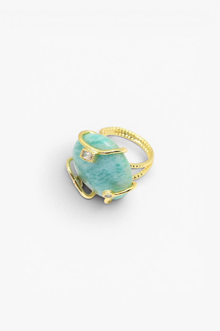 Turquoise ring with gold band on a white background