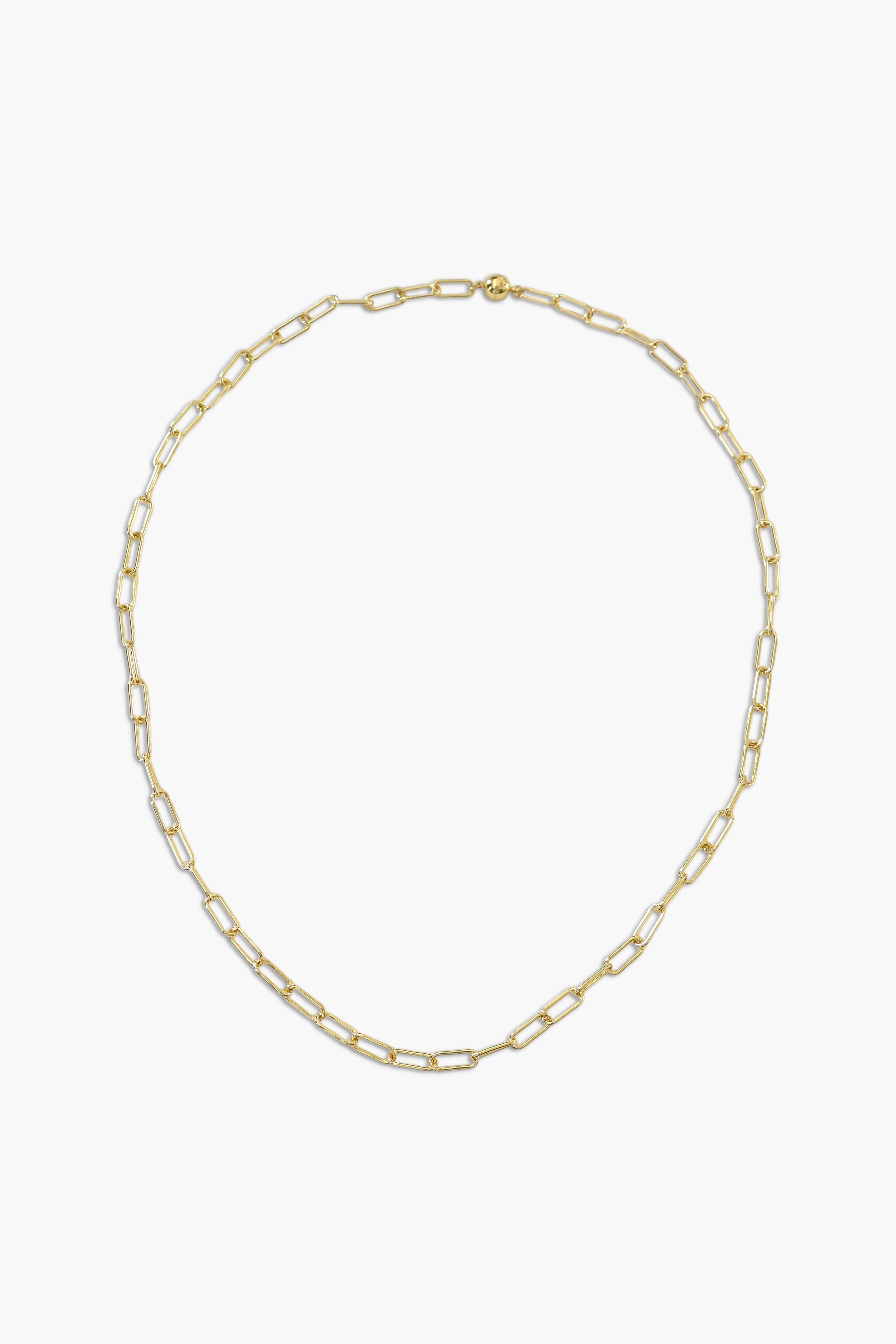 A person wearing multiple necklaces with amethyst stones and gold accents. The necklaces are part of a stack, and the person is holding some of the necklaces, showcasing the jewelry.