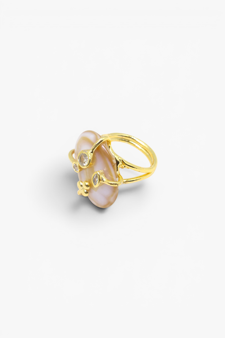 Natural stone statement ring with crystal accents in a gold-tone setting featuring an organic gemstone centerpiece.