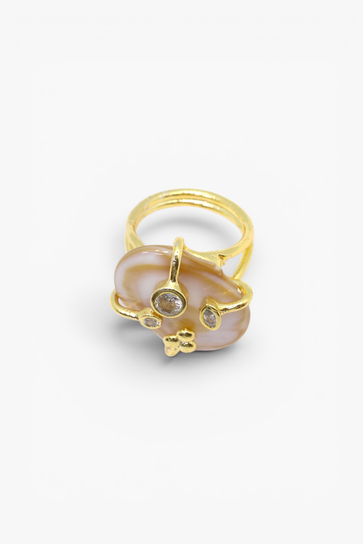 Natural stone statement ring with crystal accents in a gold-tone setting featuring an organic gemstone centerpiece.