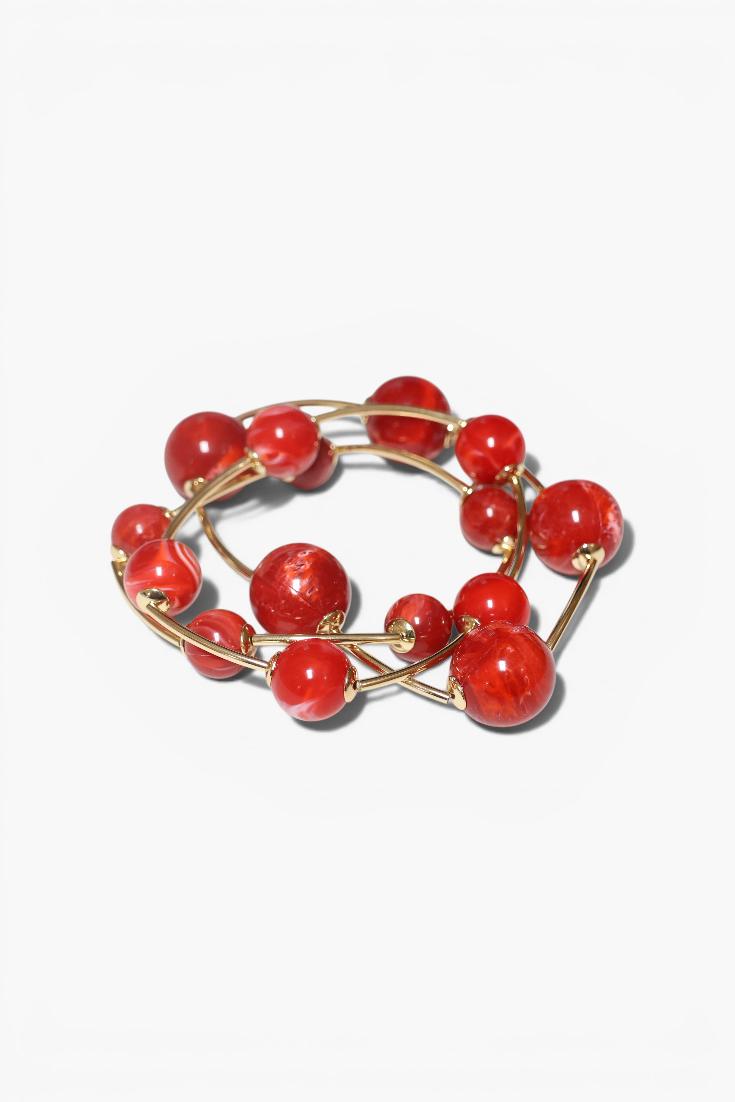 Red beaded bracelet on a white background