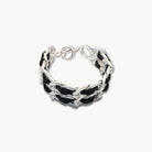 Black and silver braided bracelet on a white background