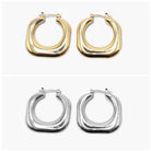 A pair of round hoop earrings, one with a gold plating and the other with a silver finish.