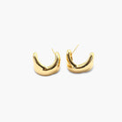 A pair of gold-colored mini hoop earrings with a textured surface.