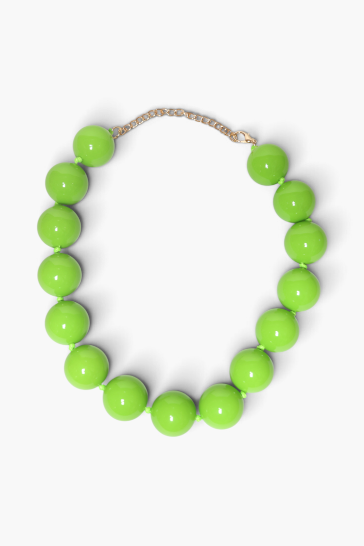 A chunky beaded necklace made of glossy, bright lime green spherical beads, connected by a delicate gold-tone chain extender, shown on a clean white background.