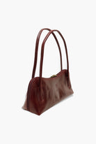 Brown leather handbag on a white background