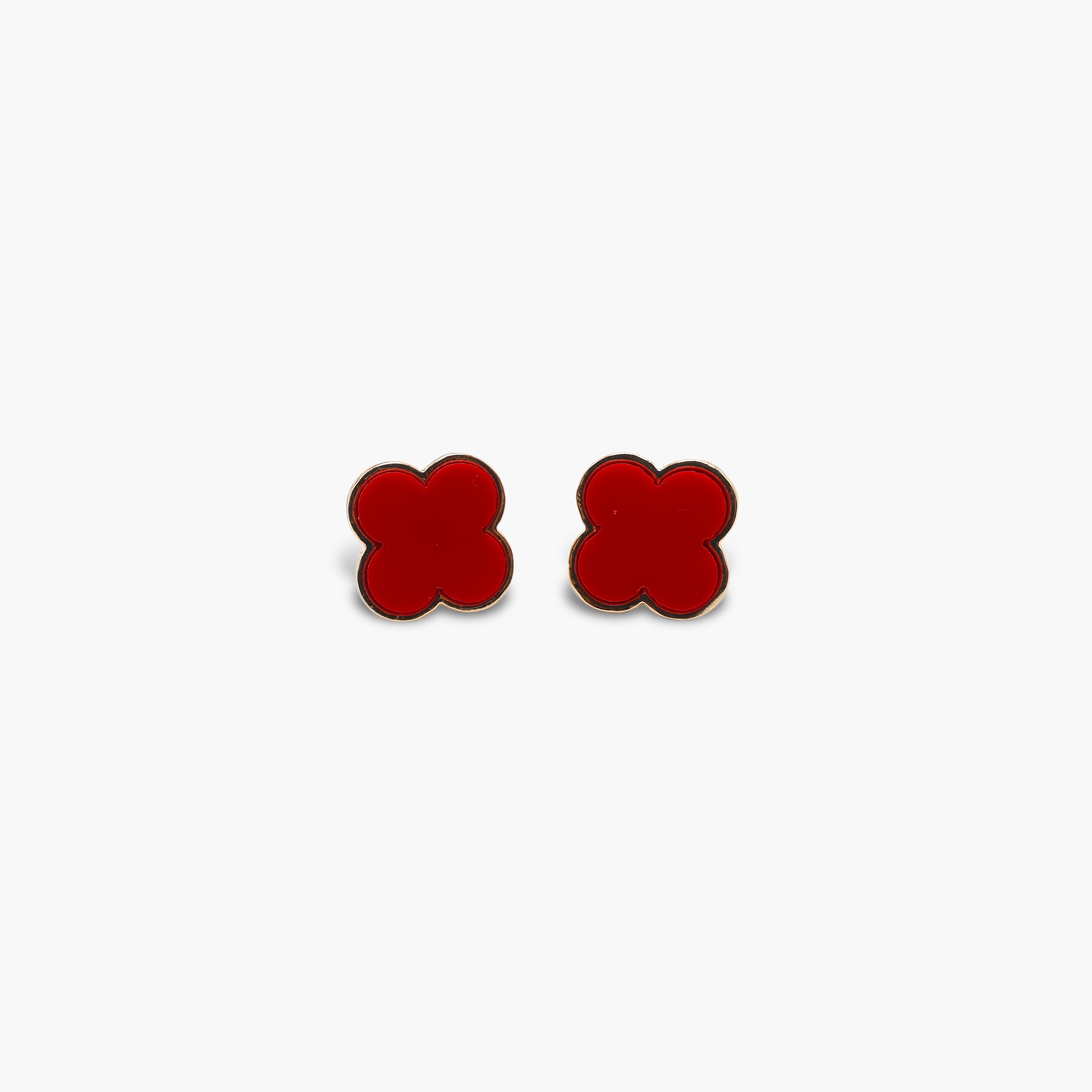 A pair of black stud earrings shaped like clovers.