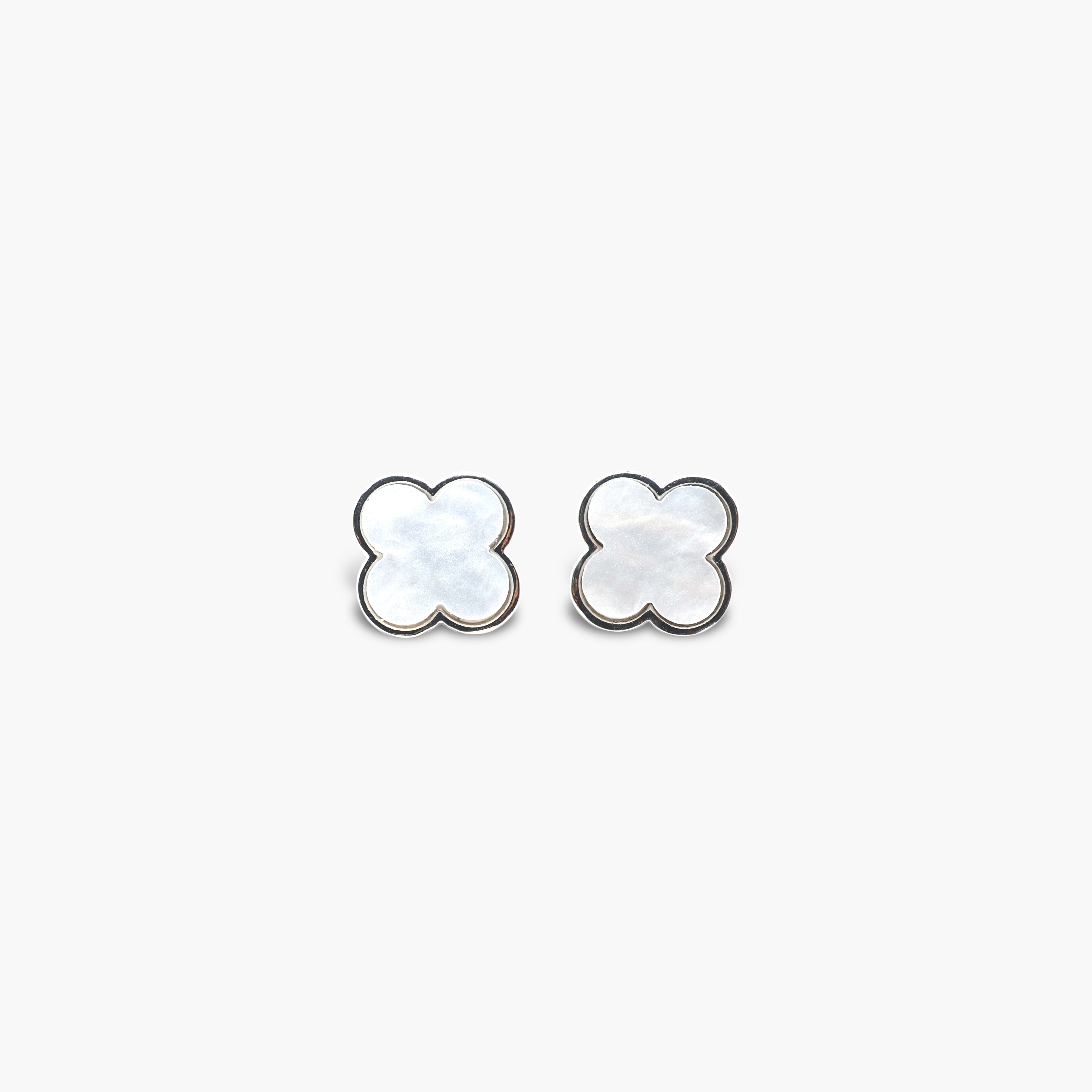 A pair of black stud earrings shaped like clovers.