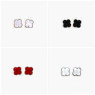 A set of four stud earrings, three with a white and black color scheme and one with a red and black color scheme.