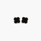 A pair of black stud earrings shaped like clovers.