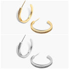 A pair of gold-colored hoop earrings with open hoops and adorned with small diamonds, displayed against a white background. The earrings are shown in two different orientations.