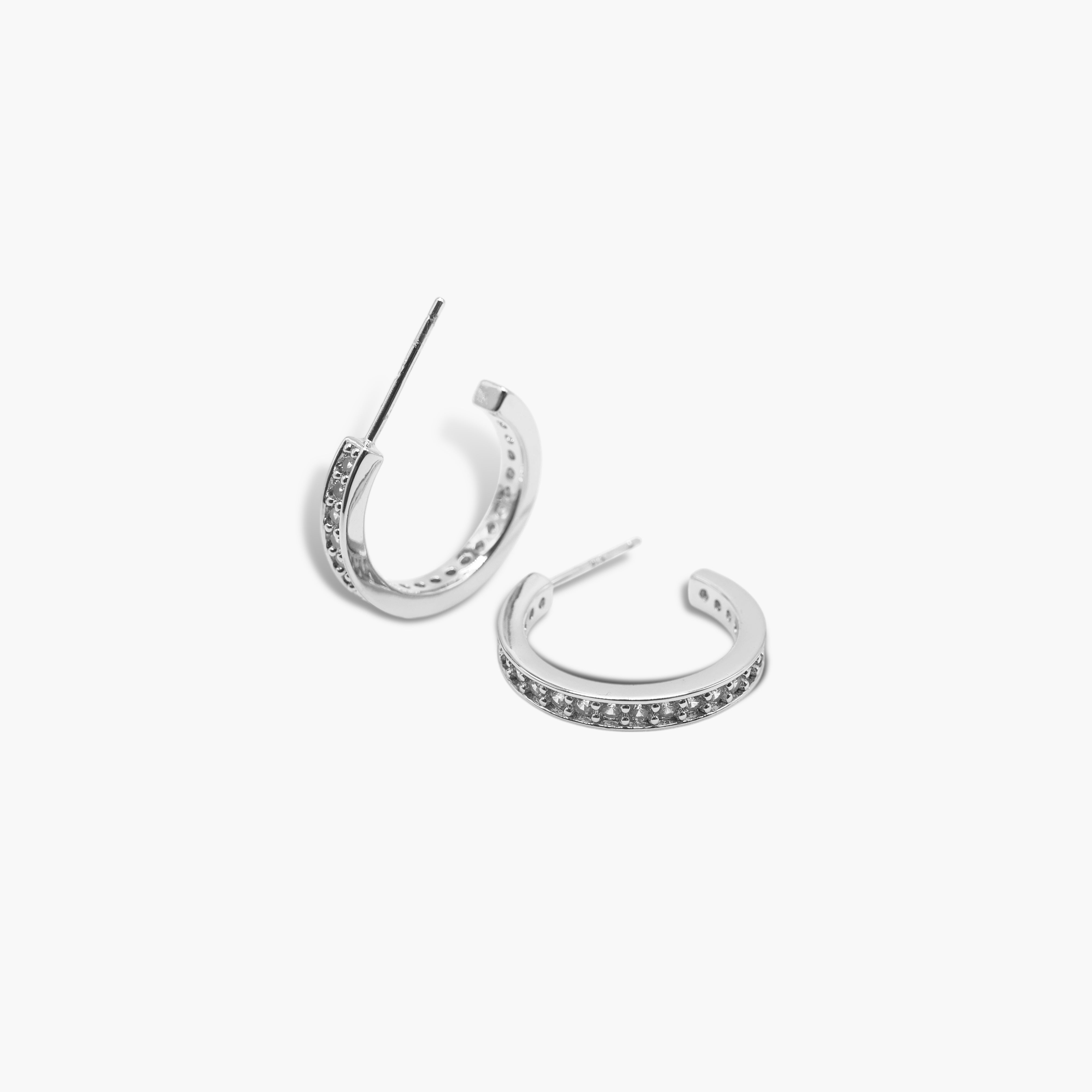 A pair of silver-colored hoop earrings with a small open hoop design and adorned with pave stones.