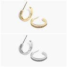 A pair of gold-colored hoop earrings with diamond accents, displayed against a white background. The earrings have an open hoop design with a small hoop size.