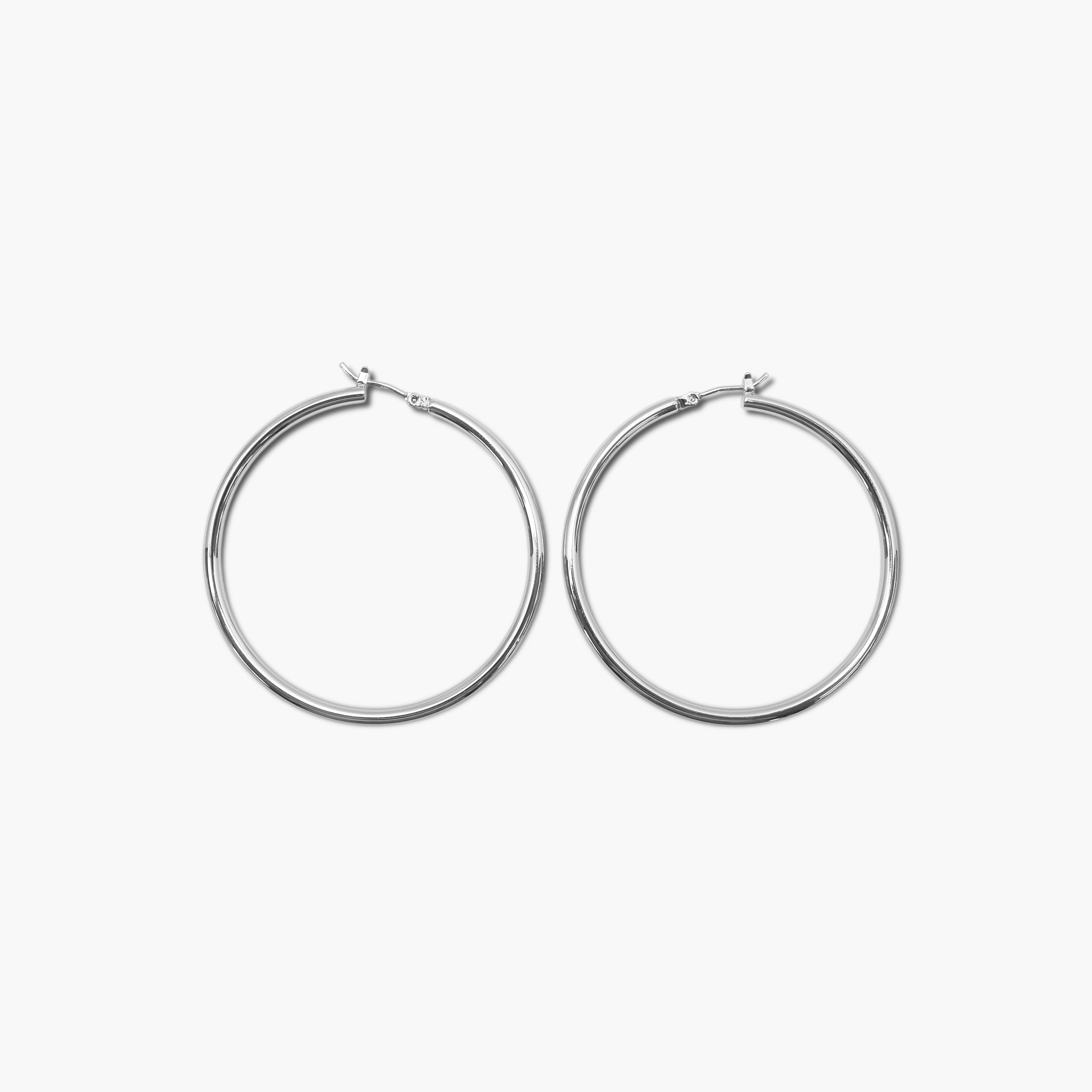 A pair of gold-colored hoop earrings on a white background
