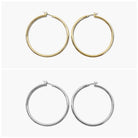 A pair of gold-colored hoop earrings with a textured surface, displayed against a white background. The earrings have a shiny finish and are shown in two different orientations.