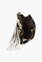 Black and white patterned handbag with tassels on a white background