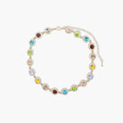 A gold dipped multi-gemstone necklace with a variety of colorful gemstones set in a circular pattern along a gold-tone chain.