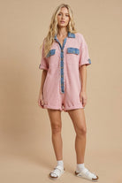 Women’s waffle knit button front romper with collared neckline, utility pockets, rolled short sleeves, and relaxed fit casual one-piece outfit for boutique fashion.