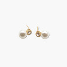 A pair of pearl post earrings with cubic zirconia accents.